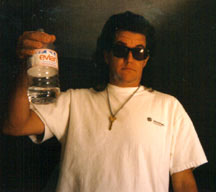 Mongo holding bottle of Evian